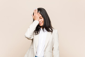 Young business chinese woman forgetting something, slapping forehead with palm and closing eyes.