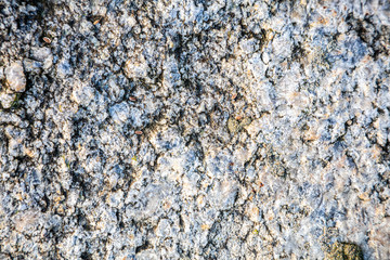 Stone background, rock wall backdrop with rough texture. Abstract, grungy and textured surface of stone material. Nature detail of rocks.