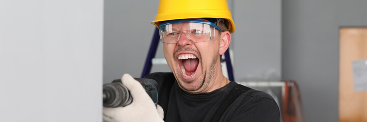 Crasy man drilling hole in the woll. Repairs in room. Violation of the noise law during construction. © H_Ko