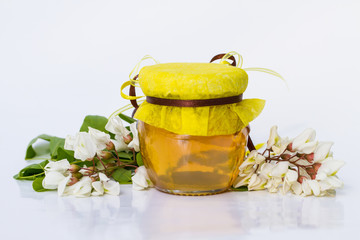 Acacia honey on white background. Robinia pseudoacacia