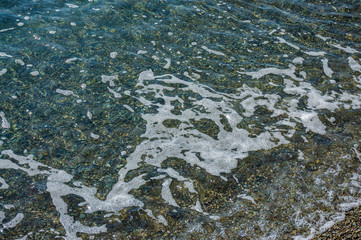 Smooth sea is traditional color of sea wave with shades of gold in rays of Crimean autumn sun. Velvet season. Calmness and relaxation. Elegant nature concept for design.