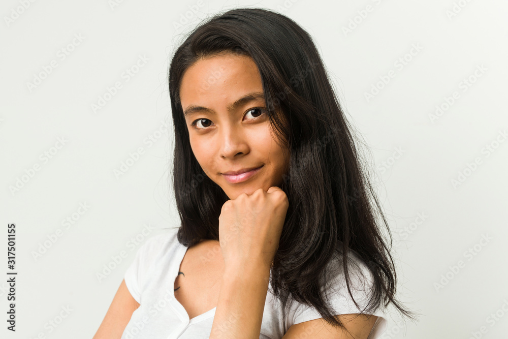 Wall mural Young chinese woman posing on a white background