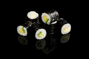 delicious sushi maki with avocado isolated on black