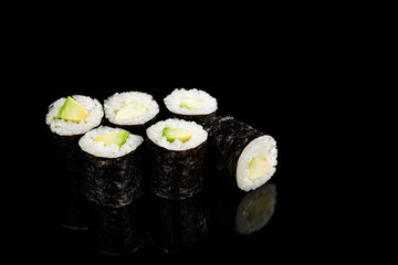 delicious sushi maki with avocado isolated on black © LIGHTFIELD STUDIOS
