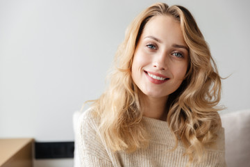 Positive optimistic young woman posing indoors at home.