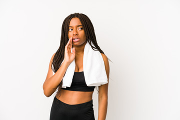 Young african american sport woman isolated is saying a secret hot braking news and looking aside