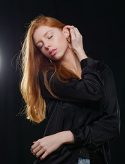 young girl with long red hair on a black background