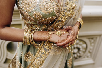 Front view of indian bridal corset with embroidery and golden wedding accessories with gemstones