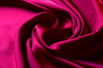 Pink color silk fabric background, top view