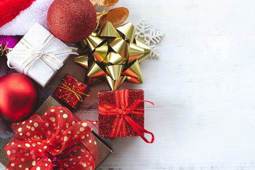 Flat lay of gift box and decoration object on wood background. Christmas and celebrations concept.