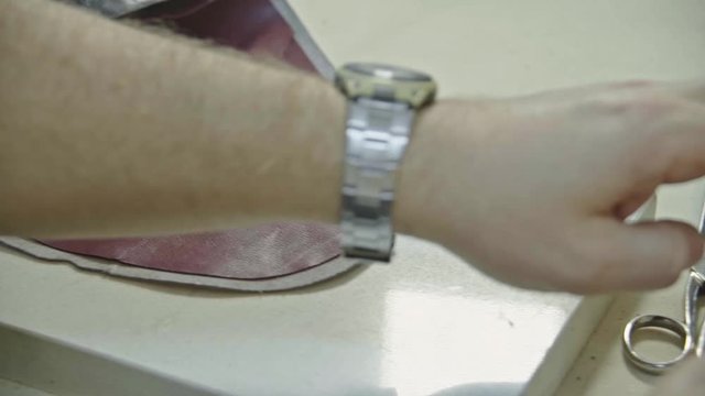 Craftsman gluing and stiching all parts of a upper part of a shoe together. 