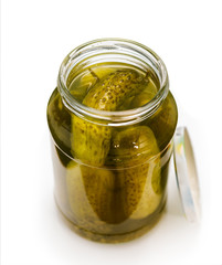 canned pickled cucumbers on white