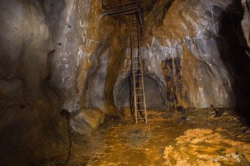 Old gold mine underground vertical shaft bottom view with stairs ladders