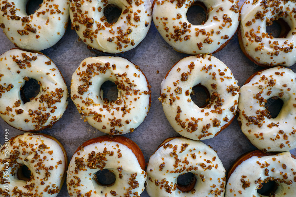 Wall mural fresh pumpkin donuts with white icing