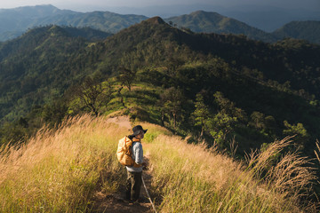 Woman hiking over the mountain ridge