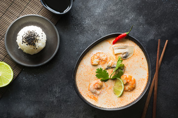 Tom yam kung spicy thai soup with shrimp, seafood, coconut milk, chili pepper and rice.