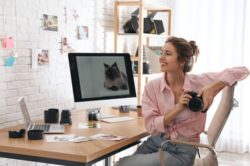 Professional photographer with camera at table in office