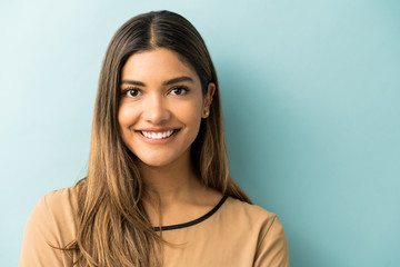 Fototapeta premium Smiling Woman Standing Against Blue Background
