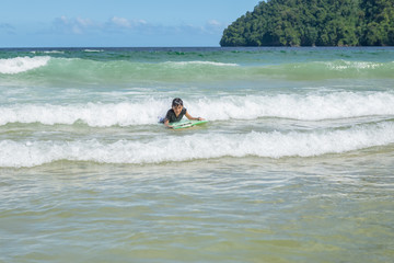 Fototapeta na wymiar Older boy swimming in Maracas Bay Beach Trinidad