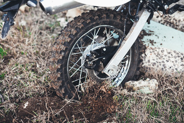 Action the wheel of an Enduro Motorcycle Hits an obstacle in the ground