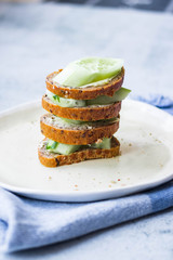 Healthy sandwich. Rye bread with no yeast, spinach leaves, cucumbers. Vegan food and healthy diet.