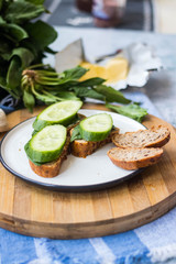 Healthy sandwich. Rye bread with no yeast, spinach leaves, cucumbers. Vegan food and healthy diet.
