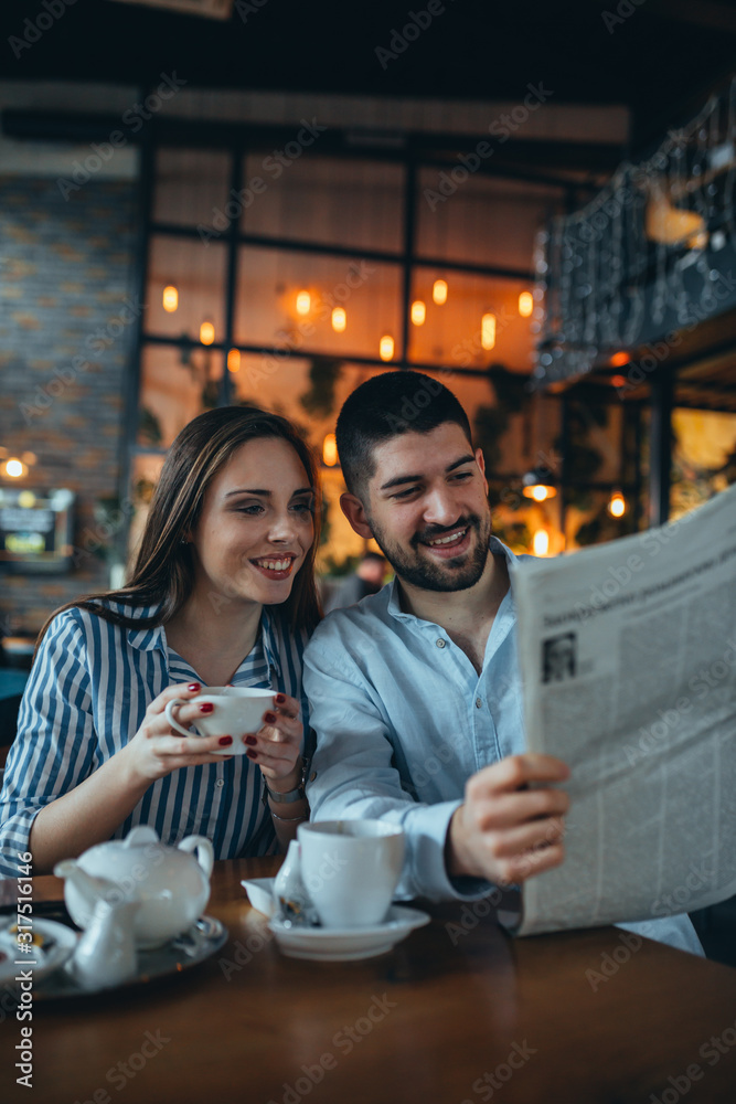 Wall mural romantic couple in cafe bar drinking tea