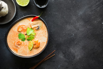 Tom yam kung spicy thai soup with shrimp, seafood, coconut milk, chili pepper and rice.