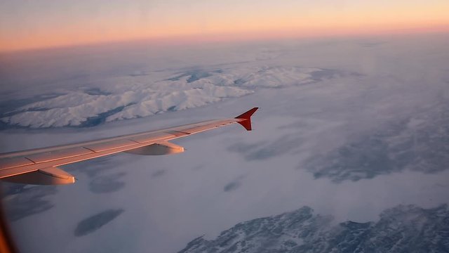 View of the Khibiny mountain above the Arctic circle in Russia's Kola peninsula from a plane flying to Murmansk at dawn in winter. The only mountains in the area, they emerge from the white plains