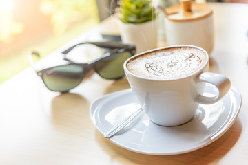 hot coffee on table / hot cappuccino with nice pattern milk foam 