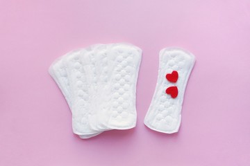 Sanitary pads on a pink background. An alternative choice of feminine hygiene products. Menstrual mothly cycle, means of protection. Top view, flat lay.