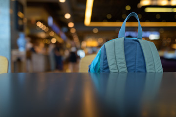 Blue Backpack Inside The Mall Against View Of Luminous Lights