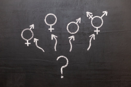 A symbol of transgender and female and male gender symbols on a chalkboard. Question mark. Freedom of choice