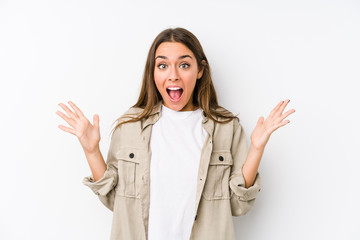 Young caucasian woman  isolated celebrating a victory or success, he is surprised and shocked.