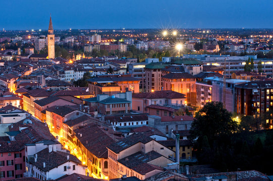 Pordenone, Corso Vittorio Emanuele II street illuminated by the lights of evening, in the background the bell tower of San Marco, Friuli Venezia Giulia, Italy, Europe