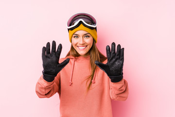 Young caucasian woman wearing a ski clothes isolated showing number ten with hands.