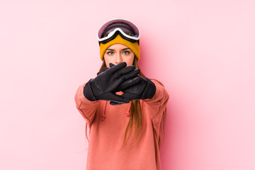 Young caucasian woman wearing a ski clothes isolated doing a denial gesture