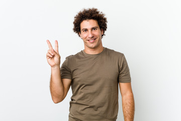 Mature handsome man isolated joyful and carefree showing a peace symbol with fingers.