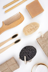 Various natural bath products and tools on white background. Spa, healthcare, beauty, treatment concept. Top view, flay lay, copy space, vertical format