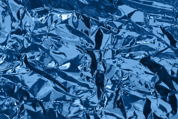 Crumpled foil colorful backdrop. Abstract background.