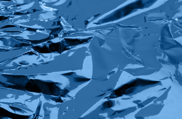 Crumpled foil colorful backdrop. Abstract background.