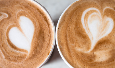 Two glasses of cappuccino. Close-up, top view. Heart on a foam