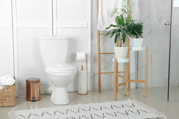 Stylish toilet bowl in modern bathroom interior
