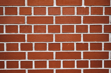 A brick wall with brown bricks and white cement in between. Seen in  Germany, April 2019