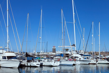 Fototapeta na wymiar Variety of yachts, sail and motor boats mooring in a harbor ,