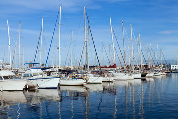 Sailing, fishing boats, yachts anchored in a small sea port, on a summer day . - 317526327