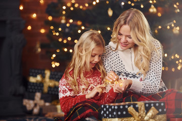 Mother and daughter with gifts celebrating christmas holidays together