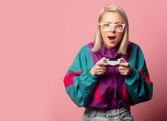 Beautiful blonde woman in 90s clothes with joystick