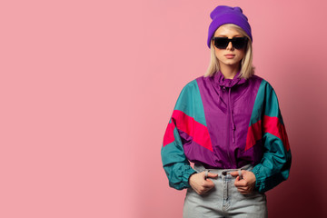 Beautiful blonde woman in sunglasses and 90s clothes