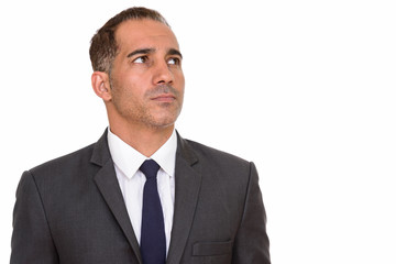 Face of mature handsome Persian businessman in suit thinking
